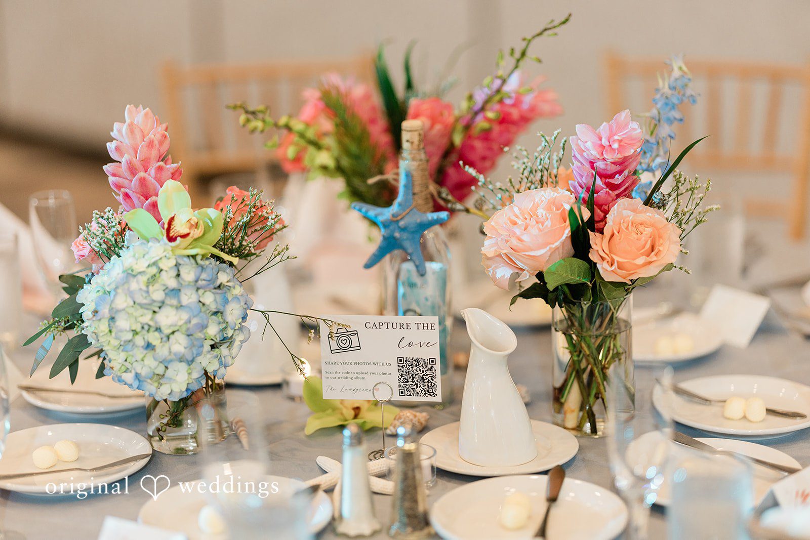 Ethan + Sydney Colorful floral centerpiece on reception table.