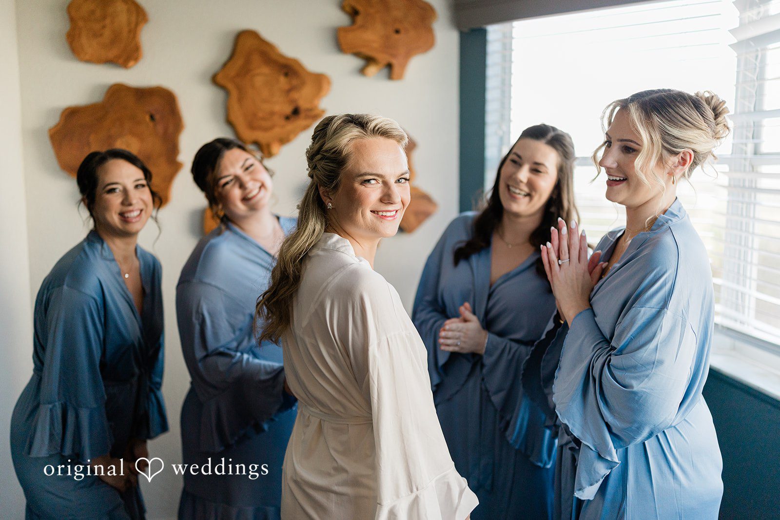 Ethan + Sydney Group smiling in wedding attire indoors.