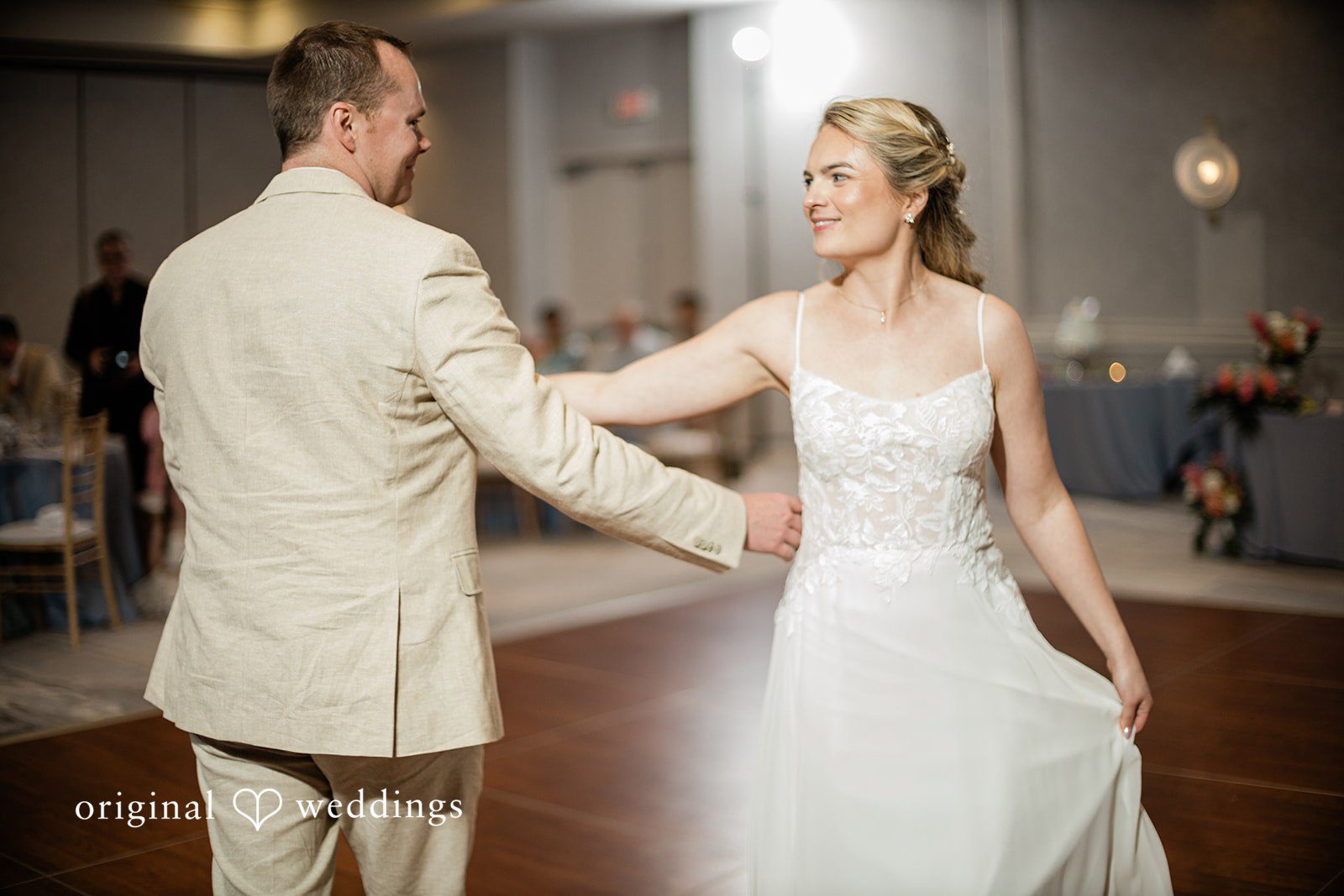 Ethan + Sydney Couple sharing first dance under soft lighting.