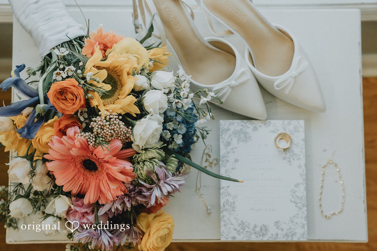 A detail shot of the bride's huge bouquet, shoes, rings, and wedding IV