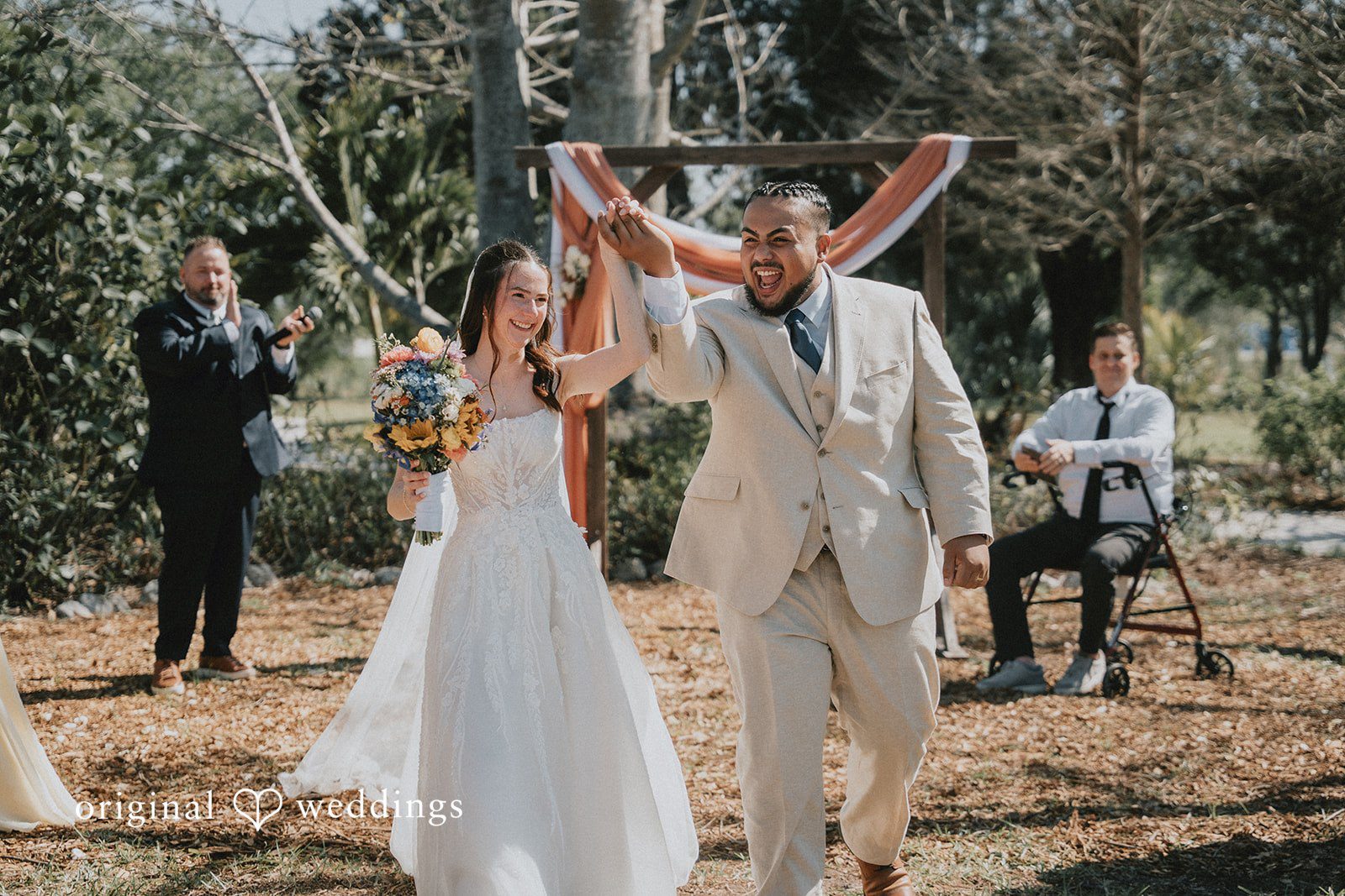 The couple makes a joyful exit after their wedding ceremony