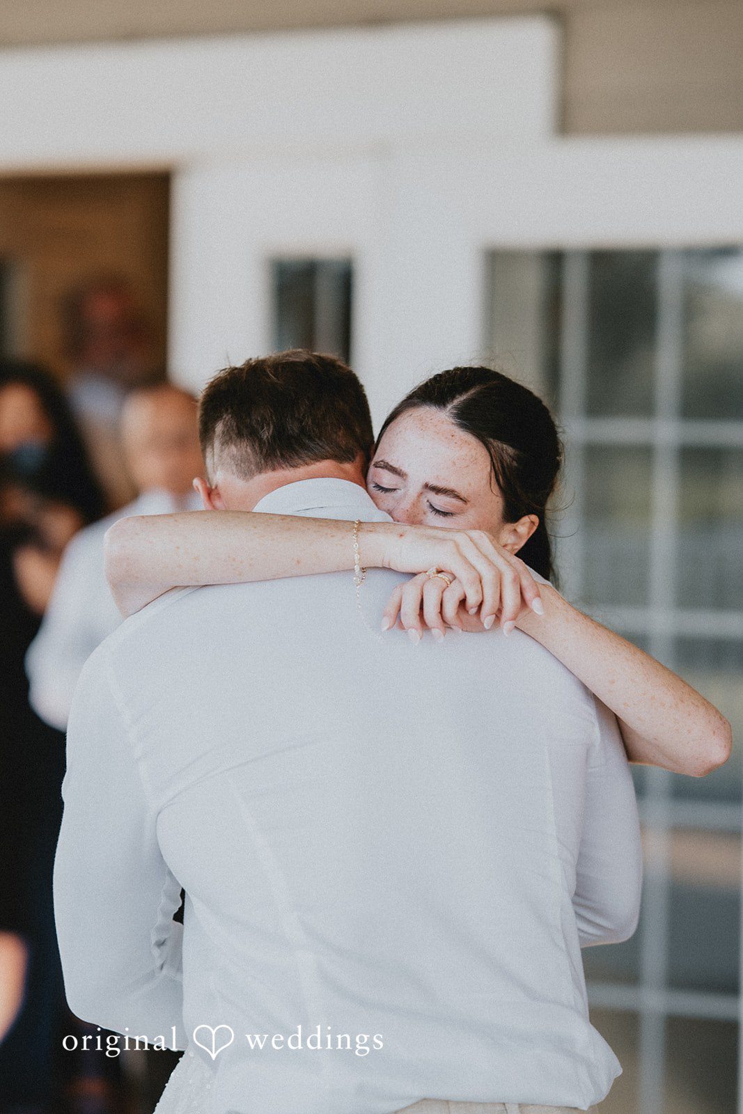 The bride shares a heartfelt hug with family