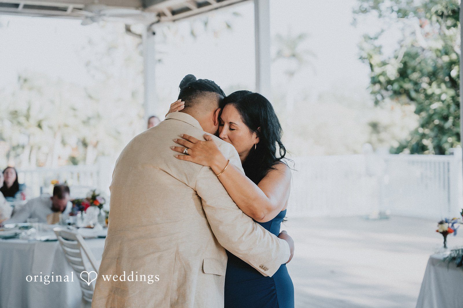 The groom shares a heartfelt hug with family