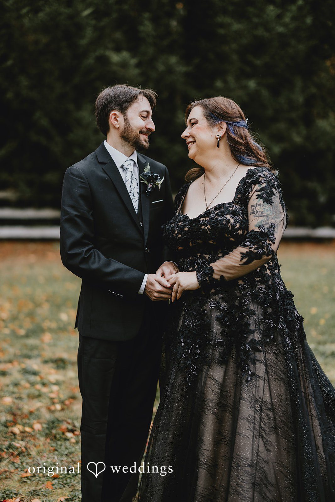 A wide outdoor shot captures the entire wedding group surrounded by autumn colors.