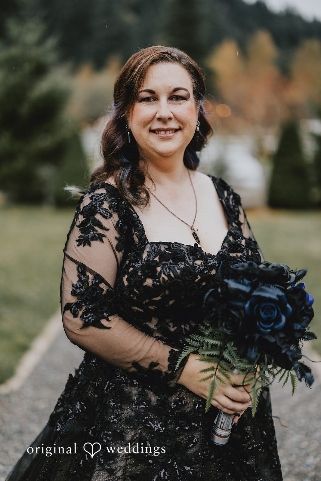 A couple standing close together outdoors creates a classic wedding portrait.