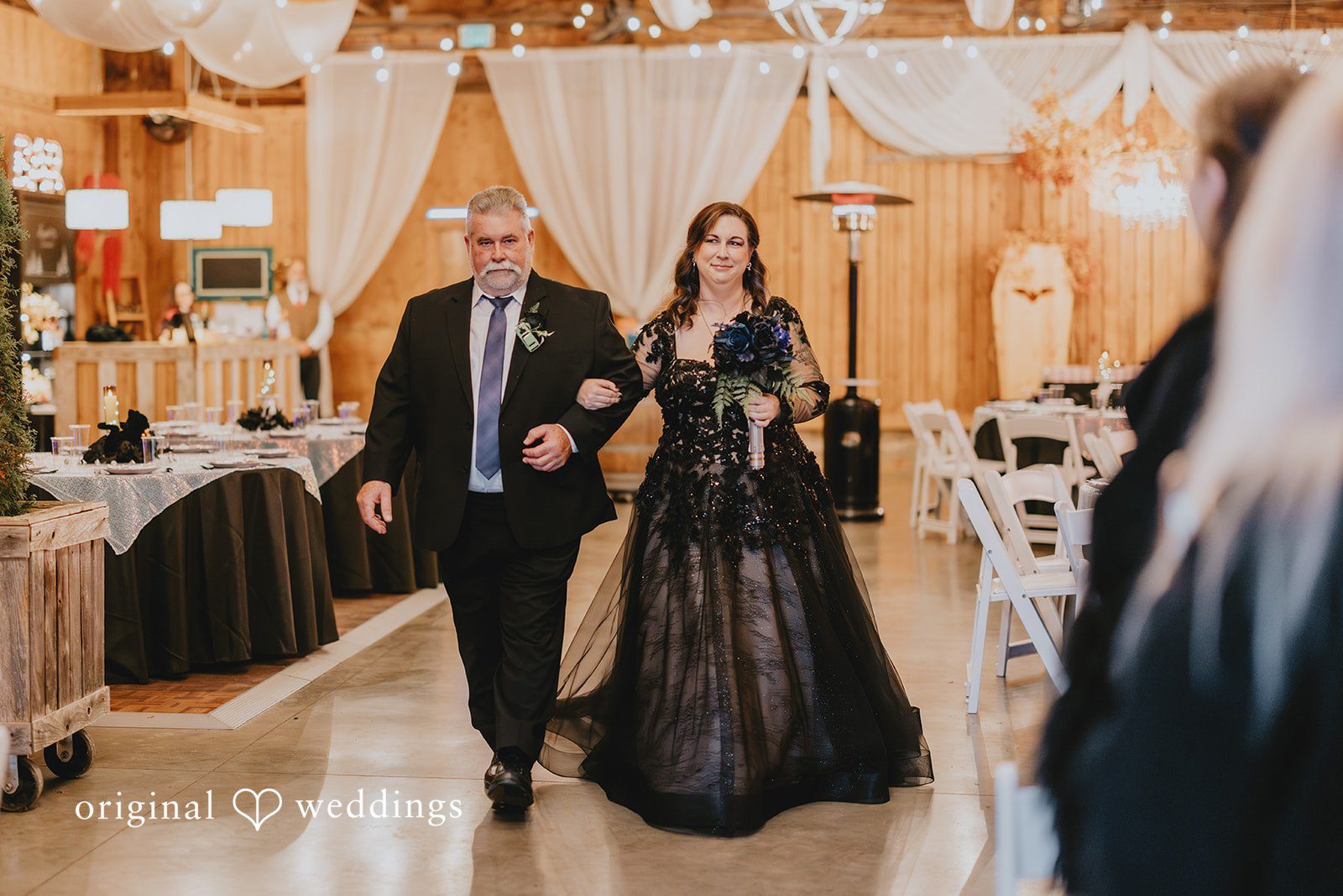 Two people walking together inside the venue mark a key transition moment during the ceremony.