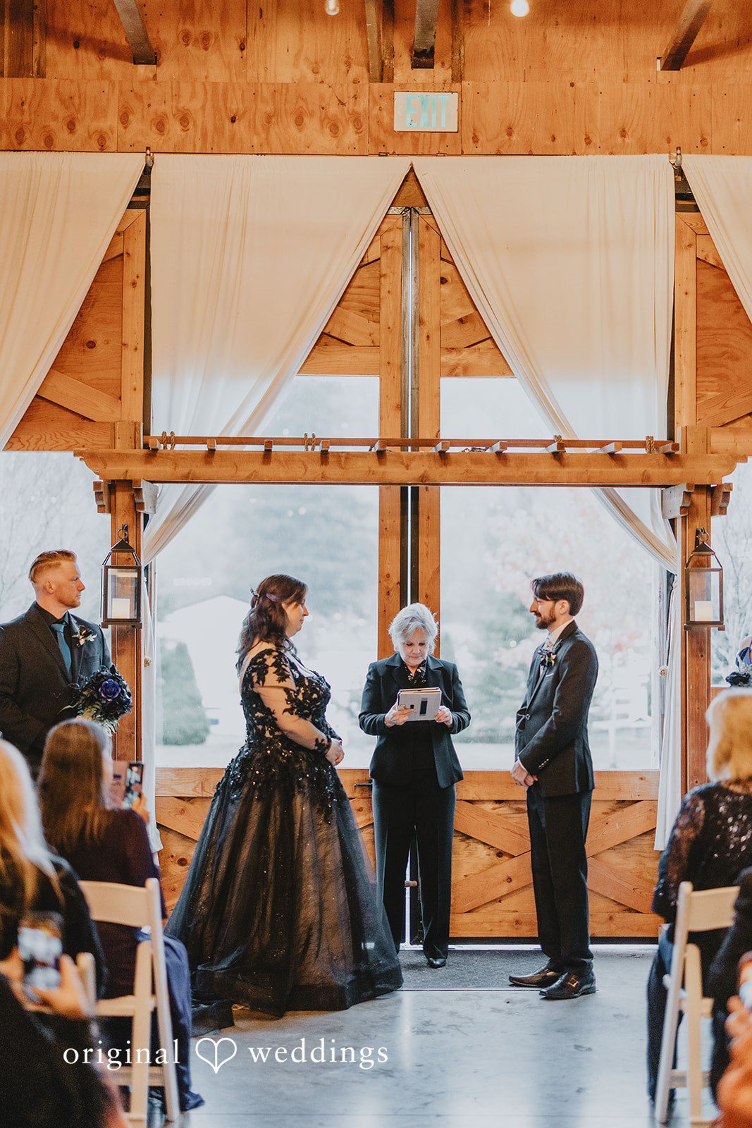 A close interior interaction between two people captures a candid ceremony moment.