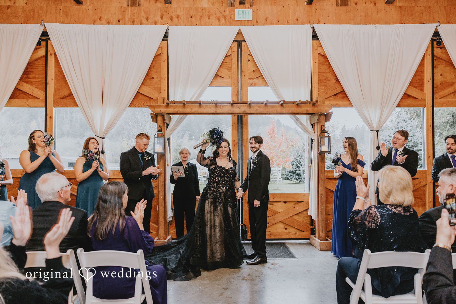 A ceremony scene with seated guests focuses attention on the front of the wooden hall.