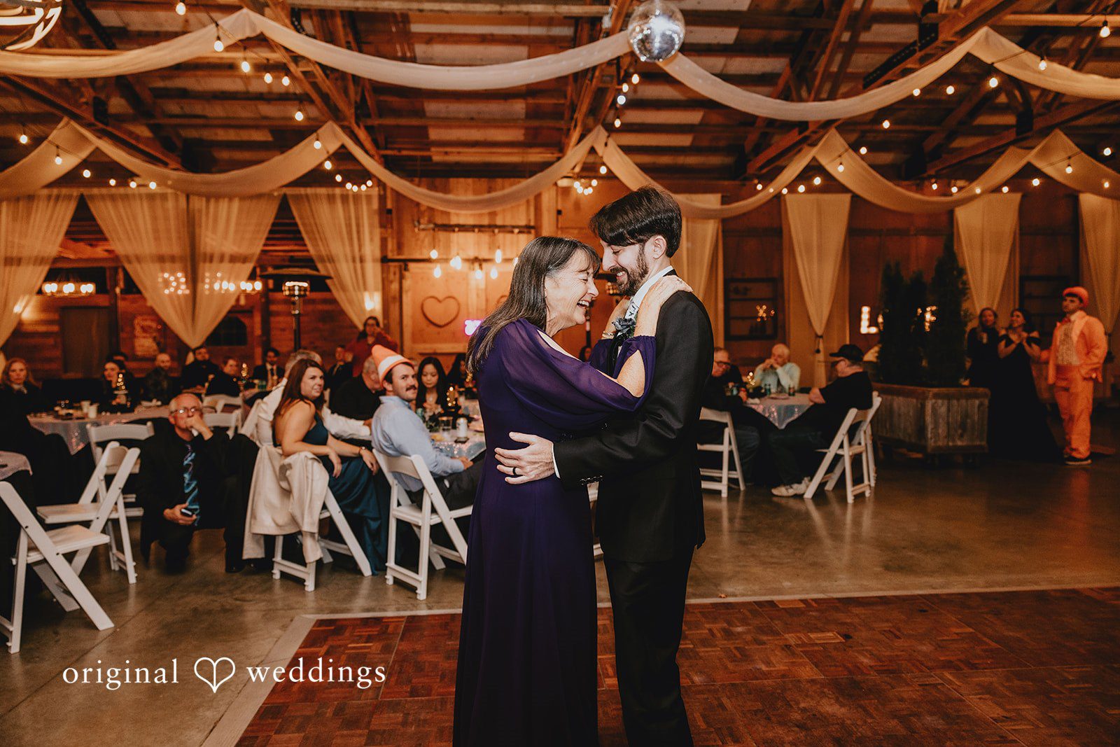 A couple walking together outdoors is photographed from behind to show motion and flow.