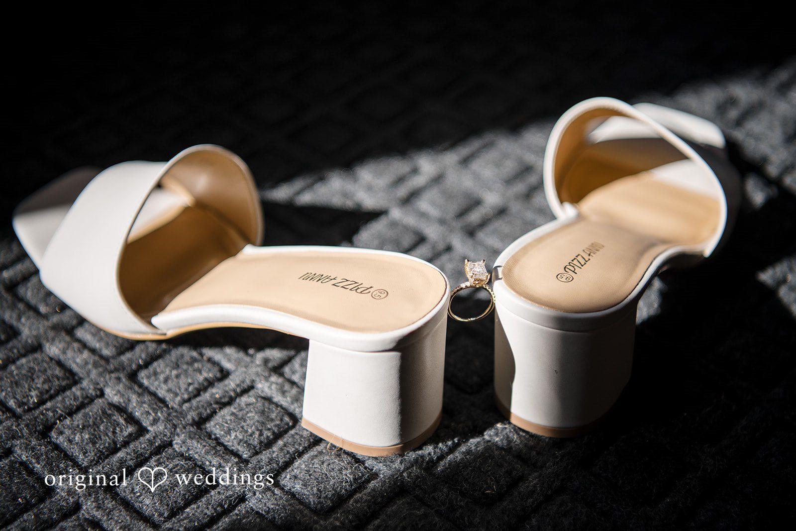 A stylish photo of the bride's shoes and wedding ring