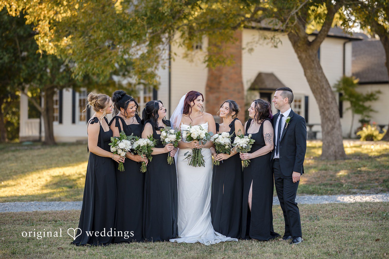 A stunning portrait of the bride and her bridal party in the outdoor area of the River Road