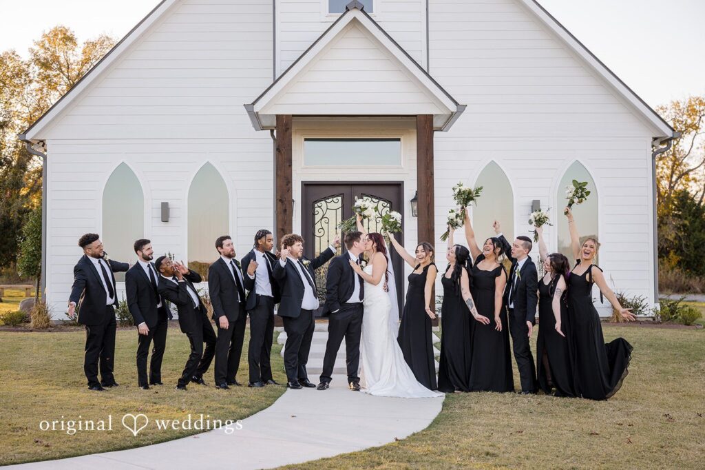 Our Dallas wedding photographer at Original Weddings captured a romantic and joyful portrait of the couple with their bridal party at the River Road wedding venue