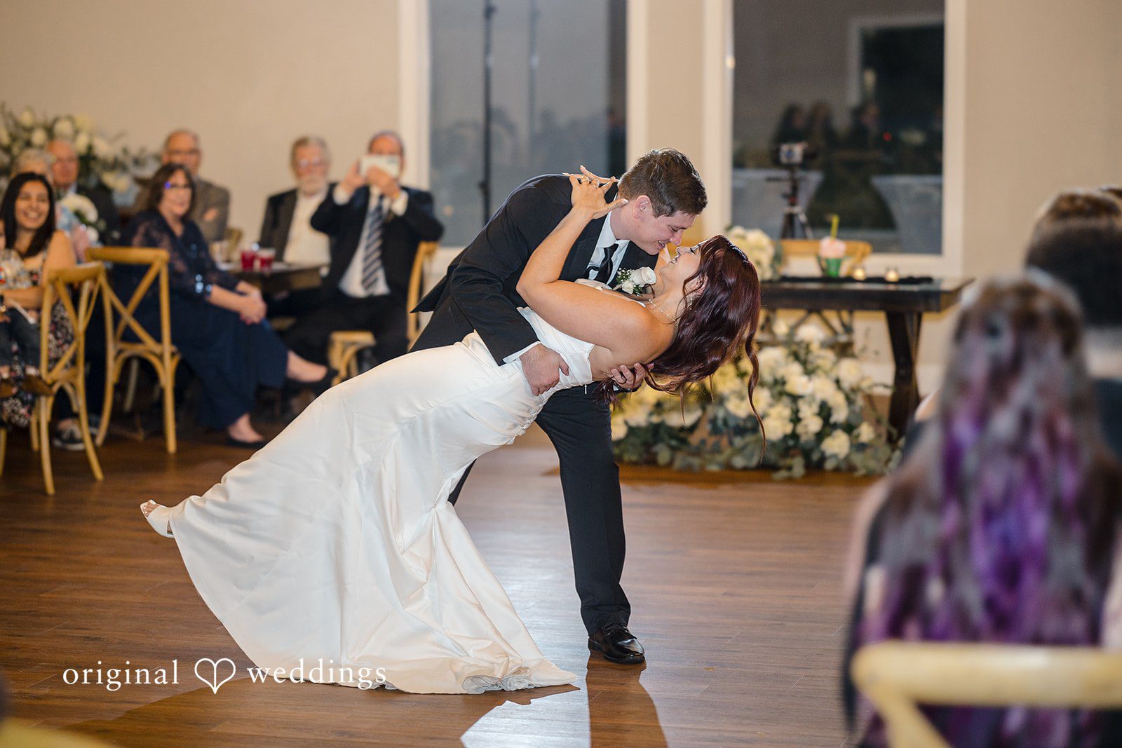 The couple takes a romantic dance at their wedding reception