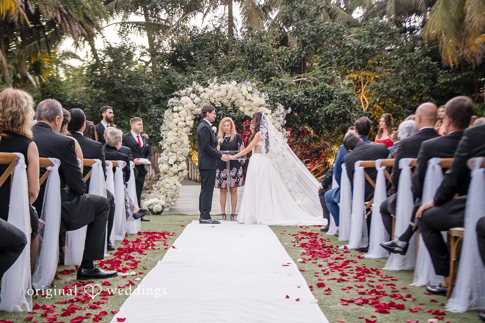 Outdoor wedding aisle moment with seated guests, Miami Wedding Photography perspective