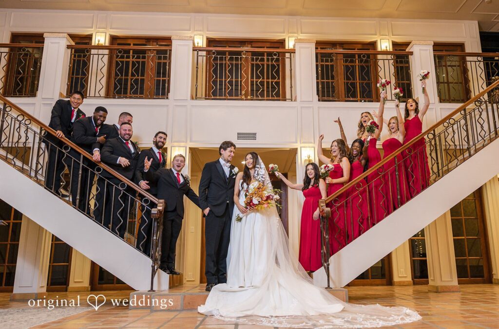Wedding party celebrating together on an indoor staircase