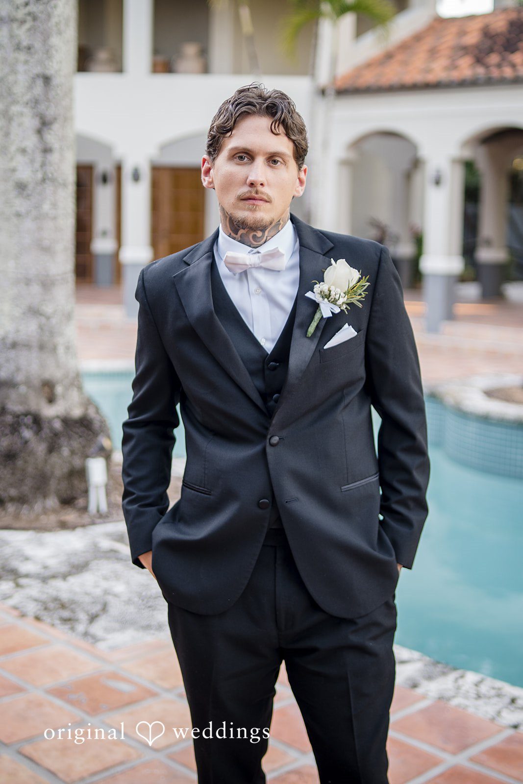Formal portrait captured outdoors near water at the wedding venue