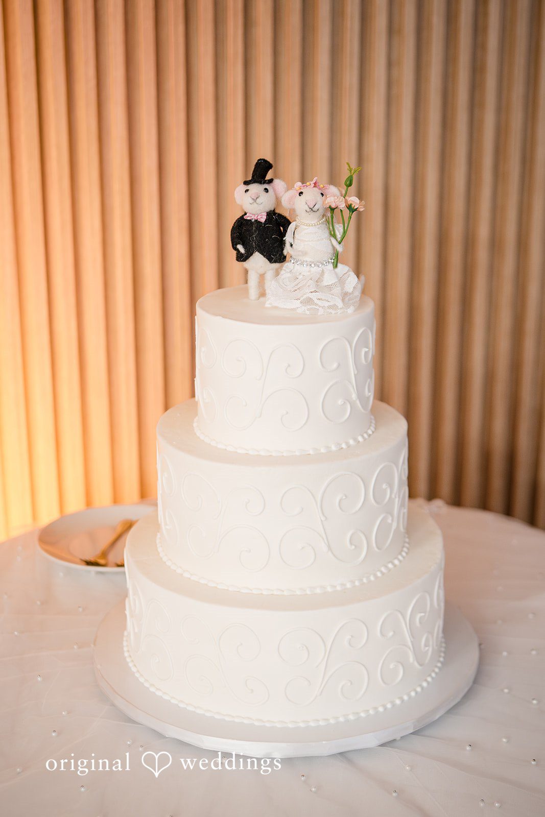 Minimal white wedding cake displayed at the reception