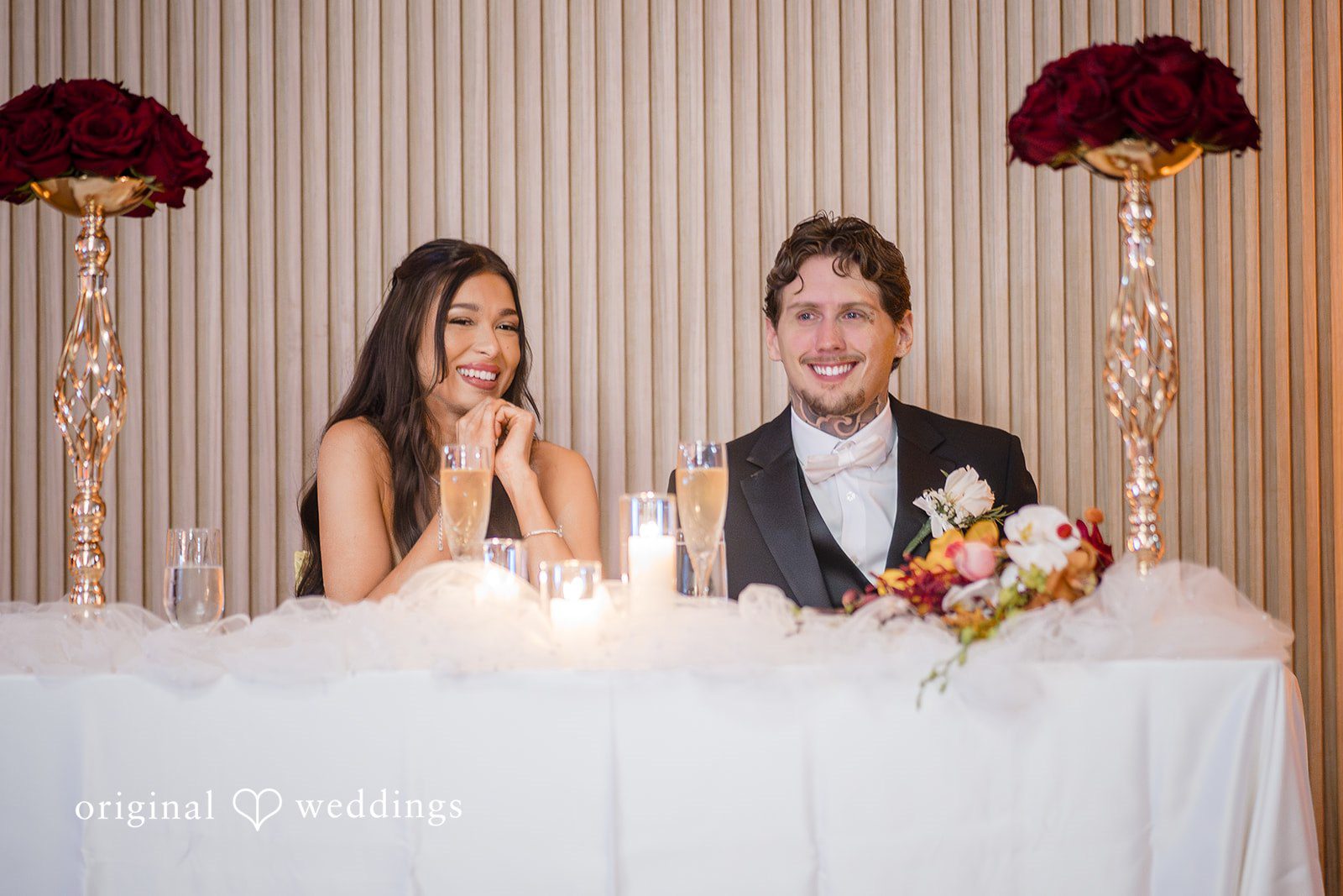 Couple seated together at the sweetheart table during reception