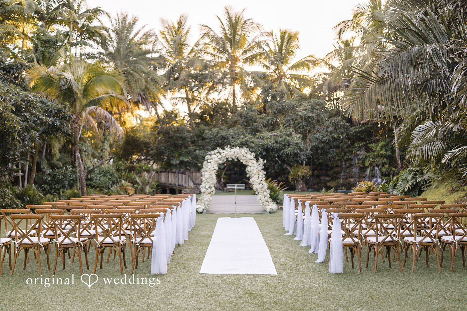 Outdoor wedding ceremony setup with white aisle and floral arch captured in Miami Wedding Photography style