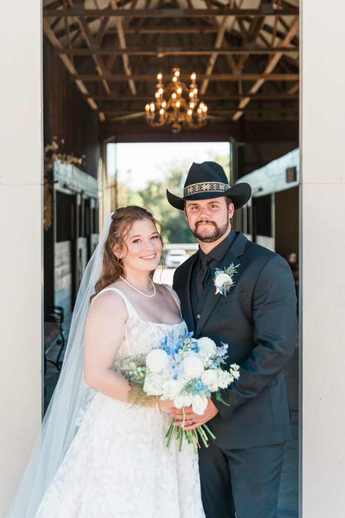 Alison + Sterlen rustic barn couple with hat at best wedding venues st louis