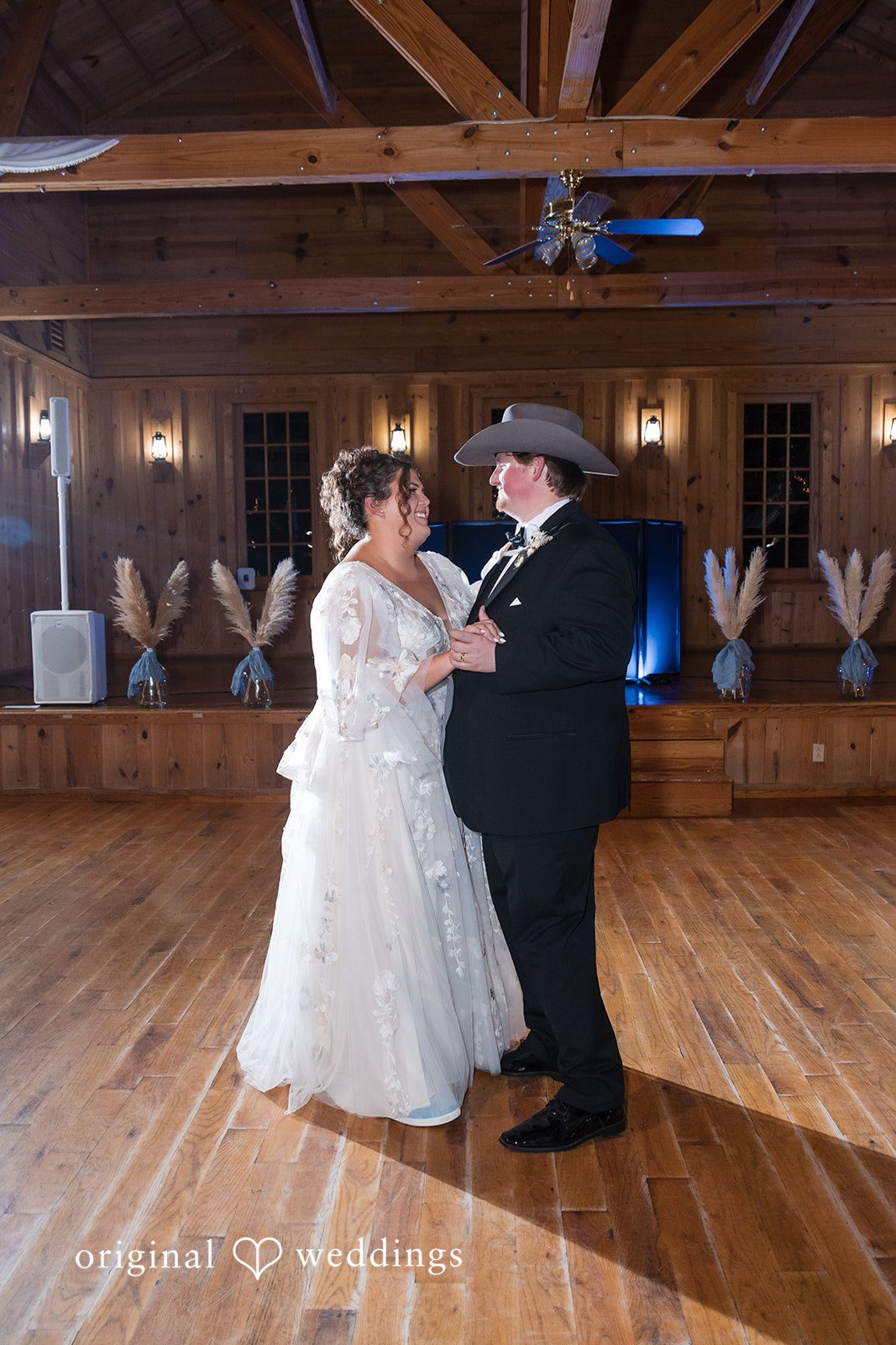 Kelsey + Riley The couple dances together on a wooden floor during the reception.