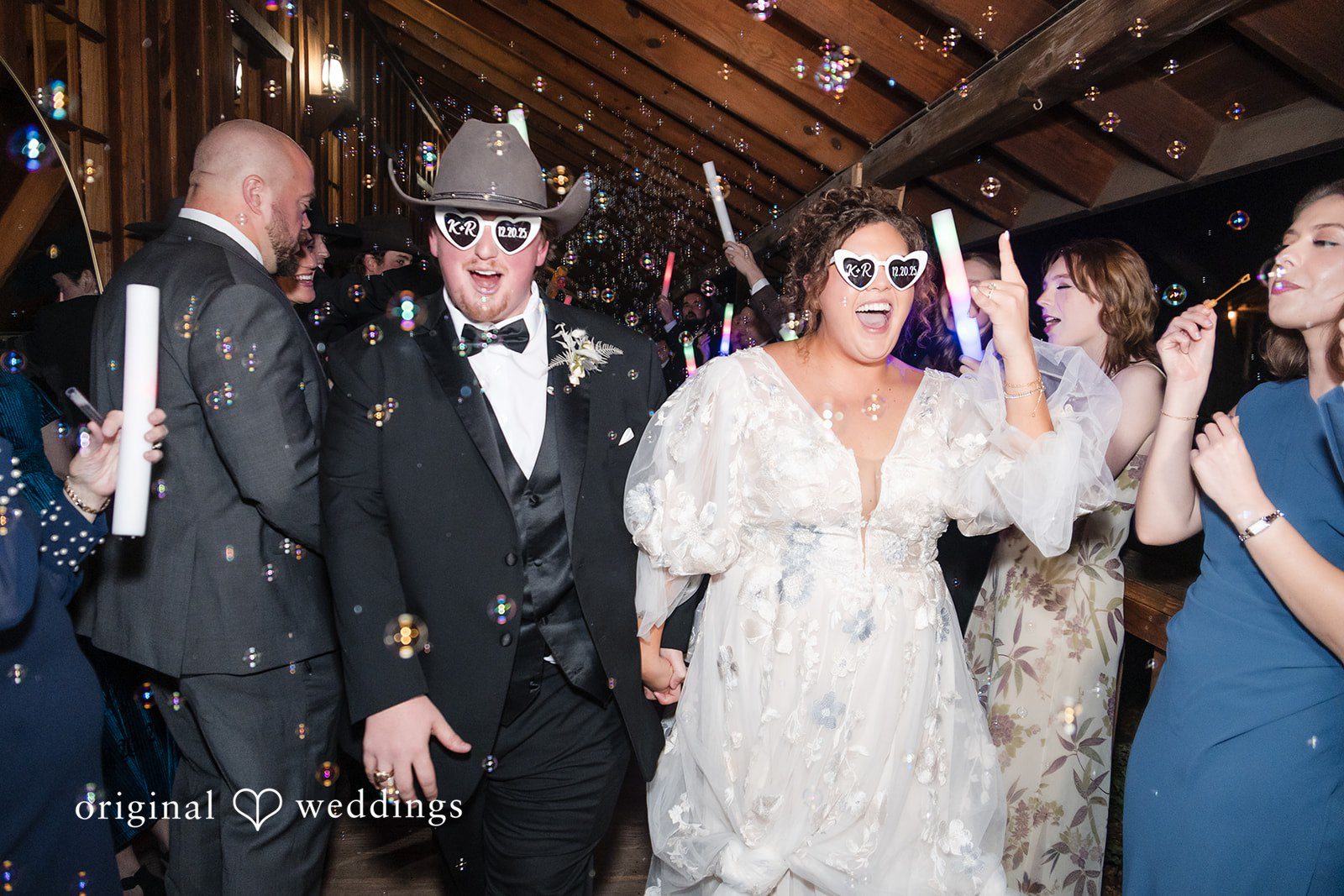 Kelsey + Riley Guests celebrate on the dance floor as the couple enjoys the party.