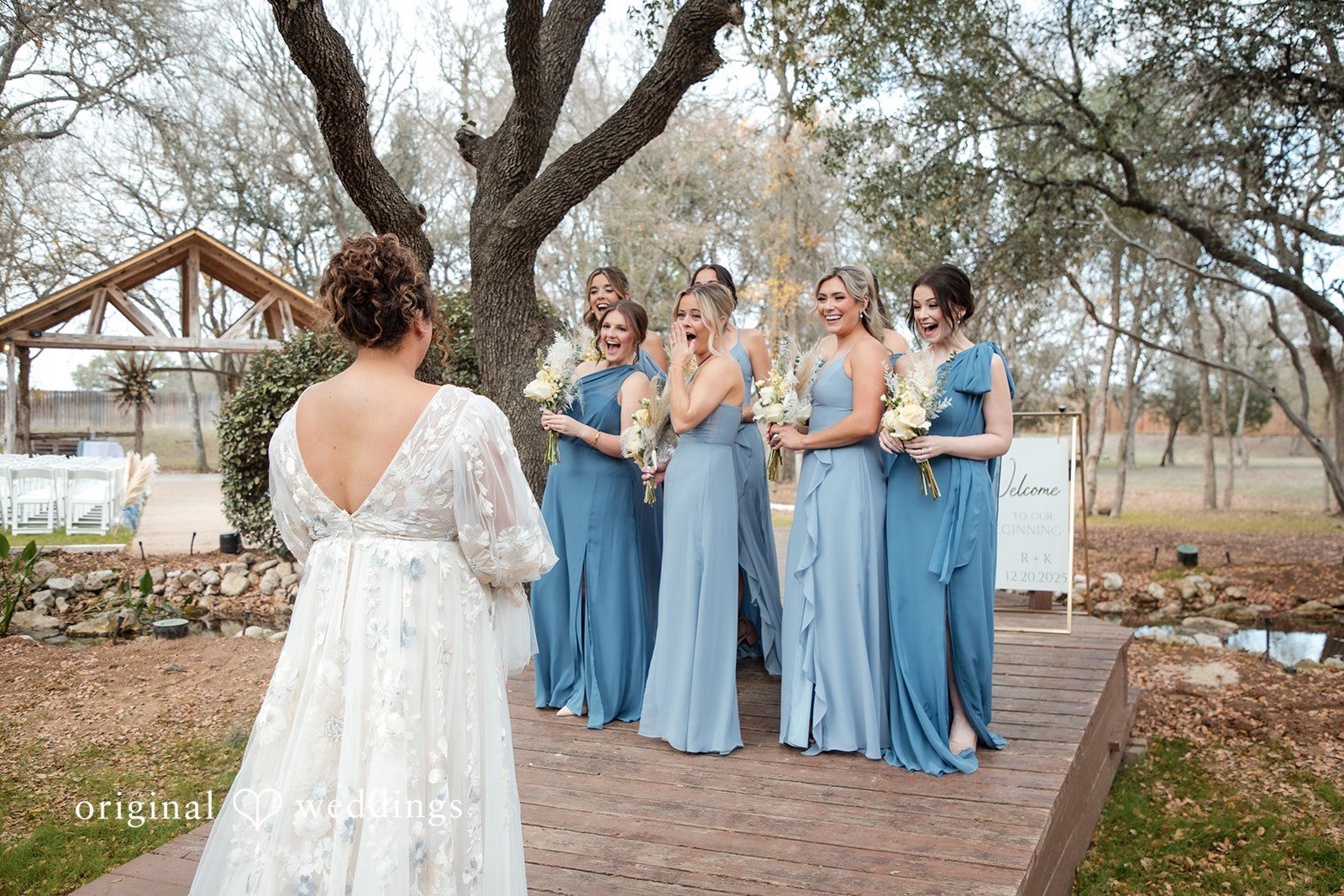 Kelsey + Riley Bridesmaids in matching blue dresses stand together outdoors.
