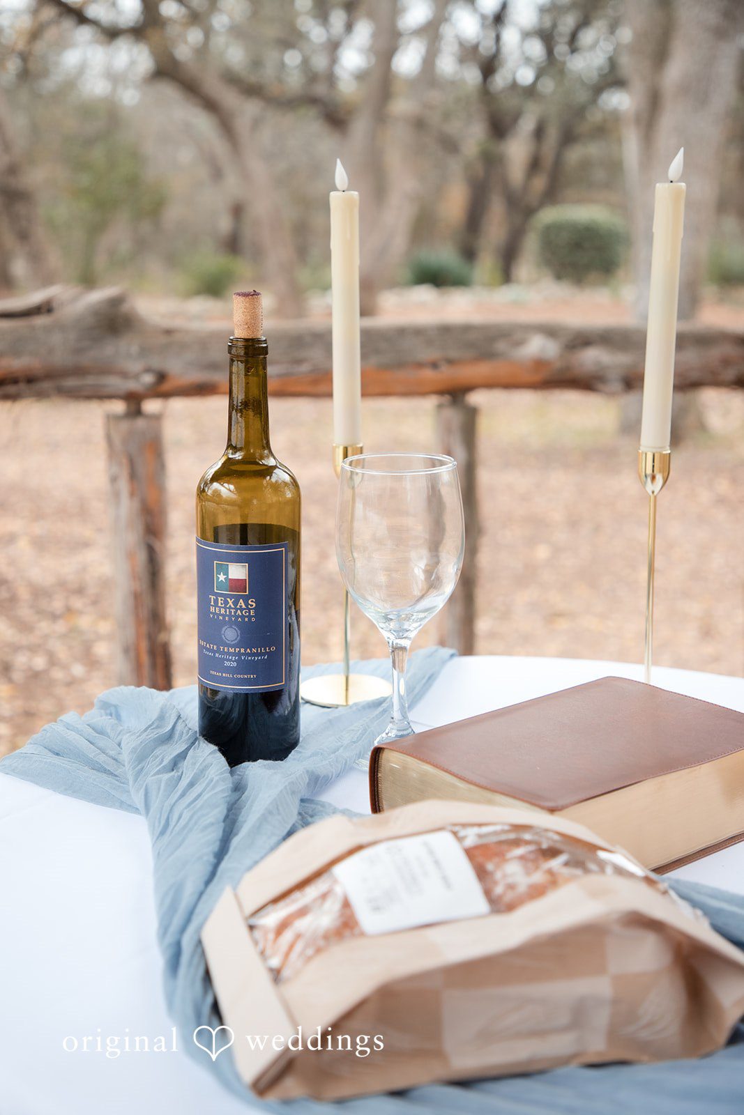 Kelsey + Riley A styled setup with wine, candles, and invitations creates a romantic scene.