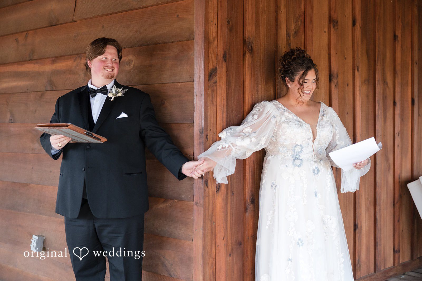 Kelsey + Riley The couple exits a wooden building hand in hand.