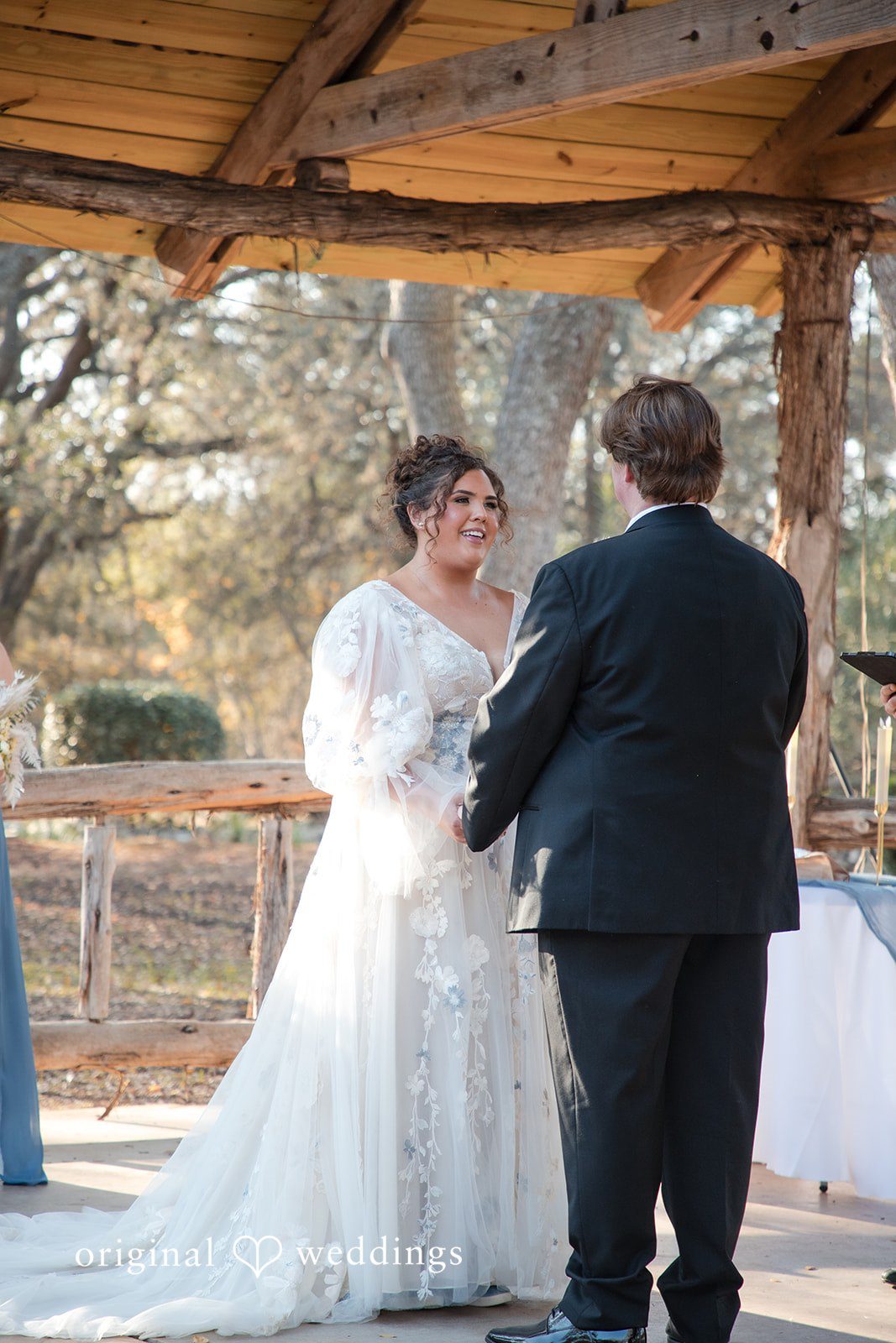 Kelsey + Riley The couple stands at the altar during their outdoor ceremony.