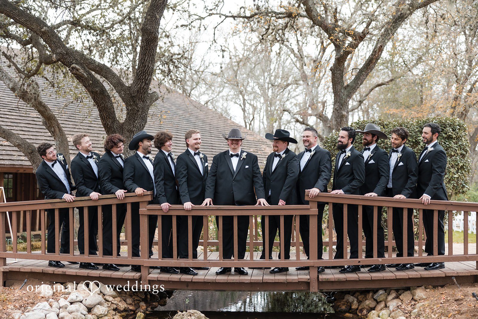 Kelsey + Riley A group of groomsmen stand together on a wooden platform.