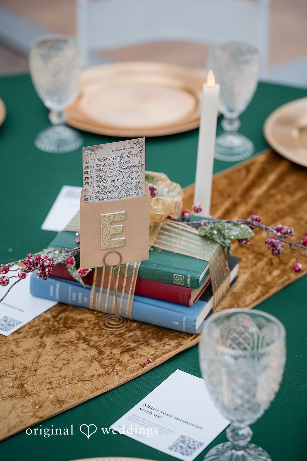 A detail shot of table decorated with books, candles, library cards, and other details
