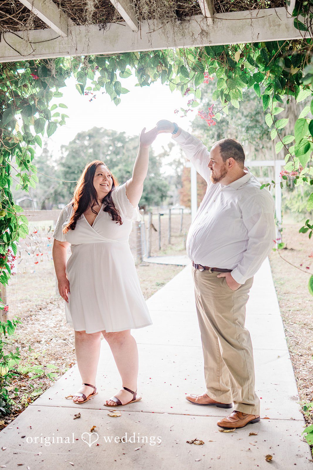 A joyful twirl while couple holding hands at The Barn at Crescent Lake in Odessa