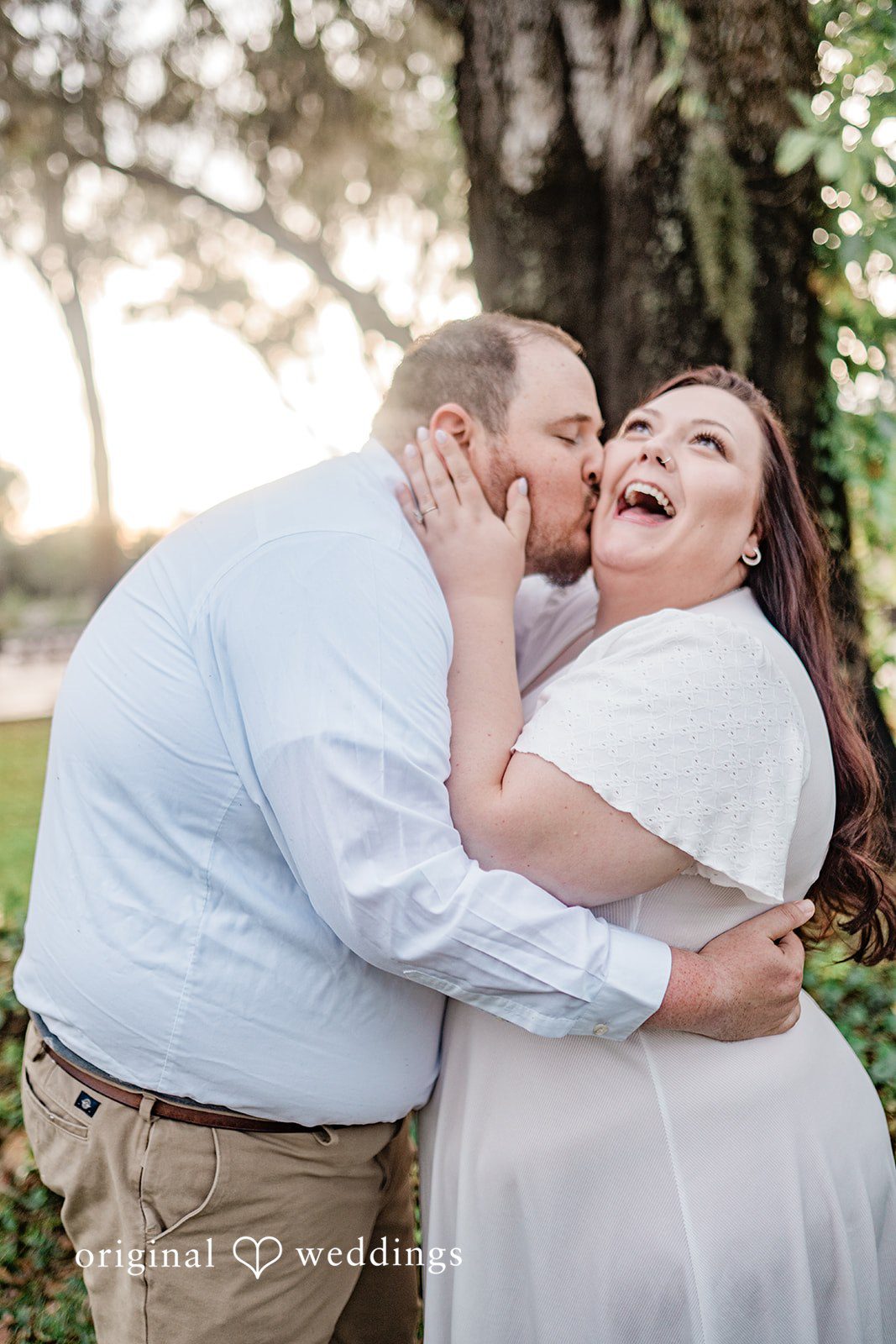 Sweet couple portrait with groom kissing bride’s cheek