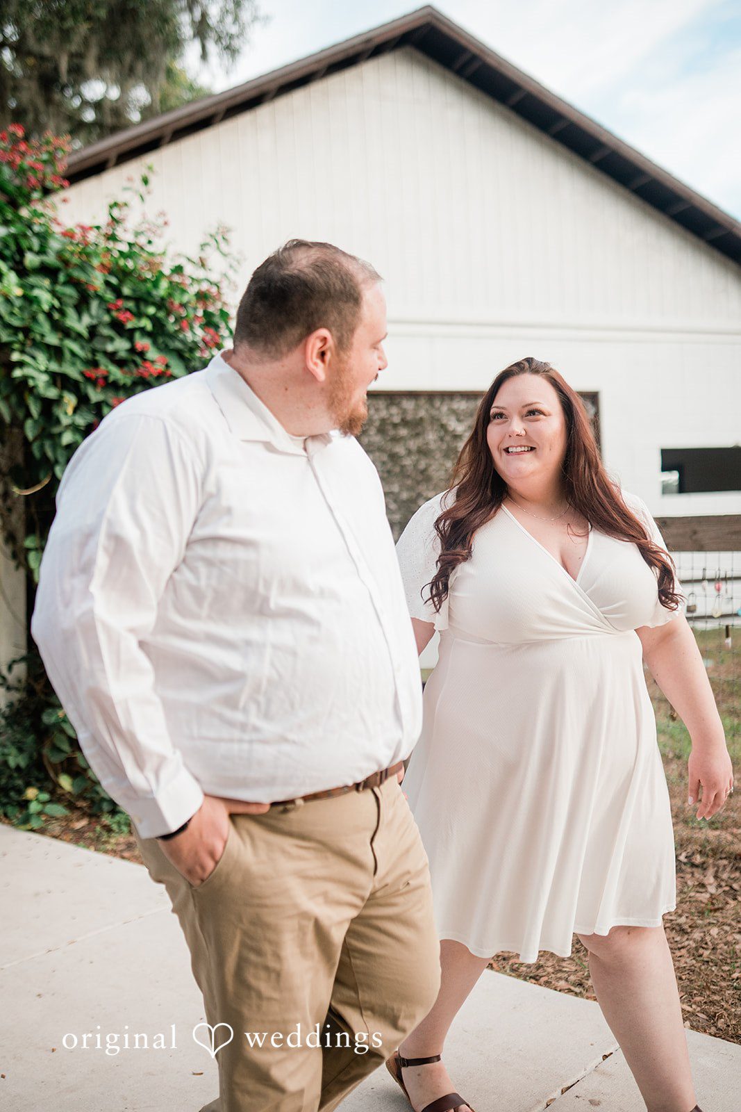 The couple holding hands and walking at The Barn at Crescent Lake in Odessa