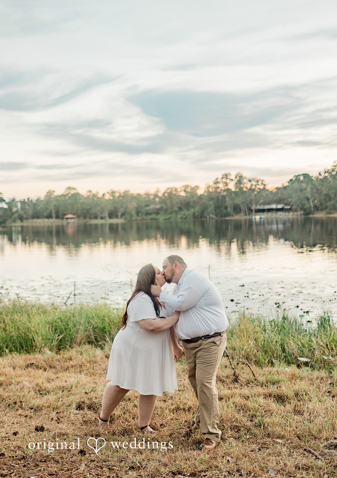 Couple sharing a romantic kiss near the lake