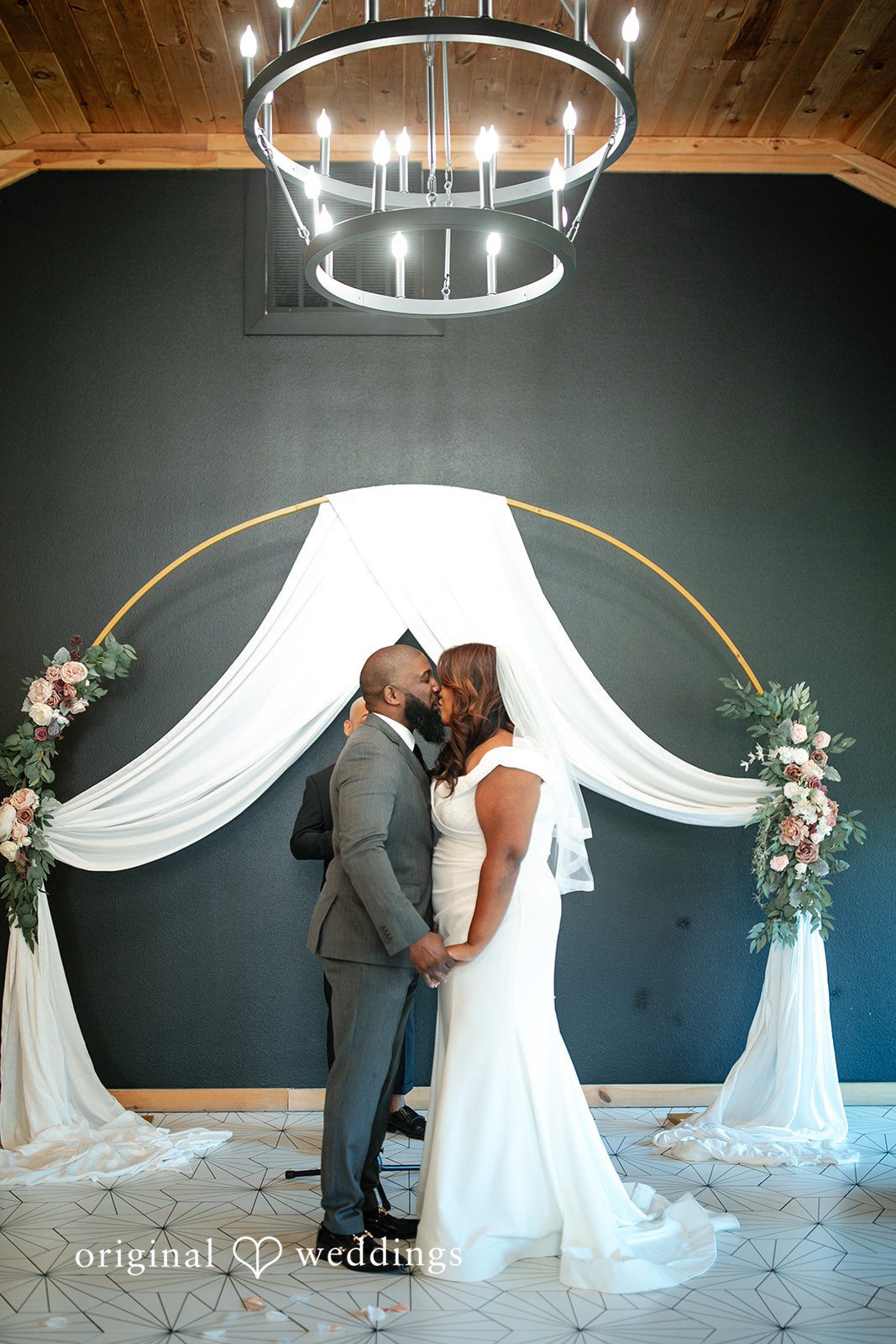 The couple seals their vow with a kiss