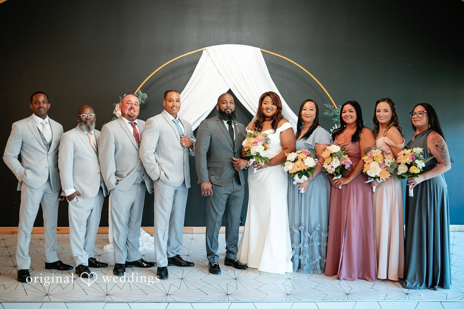 Our Orlando wedding photographers at Original Weddings captured a beautiful portrait of the couple with their bridal party at The Black Barn