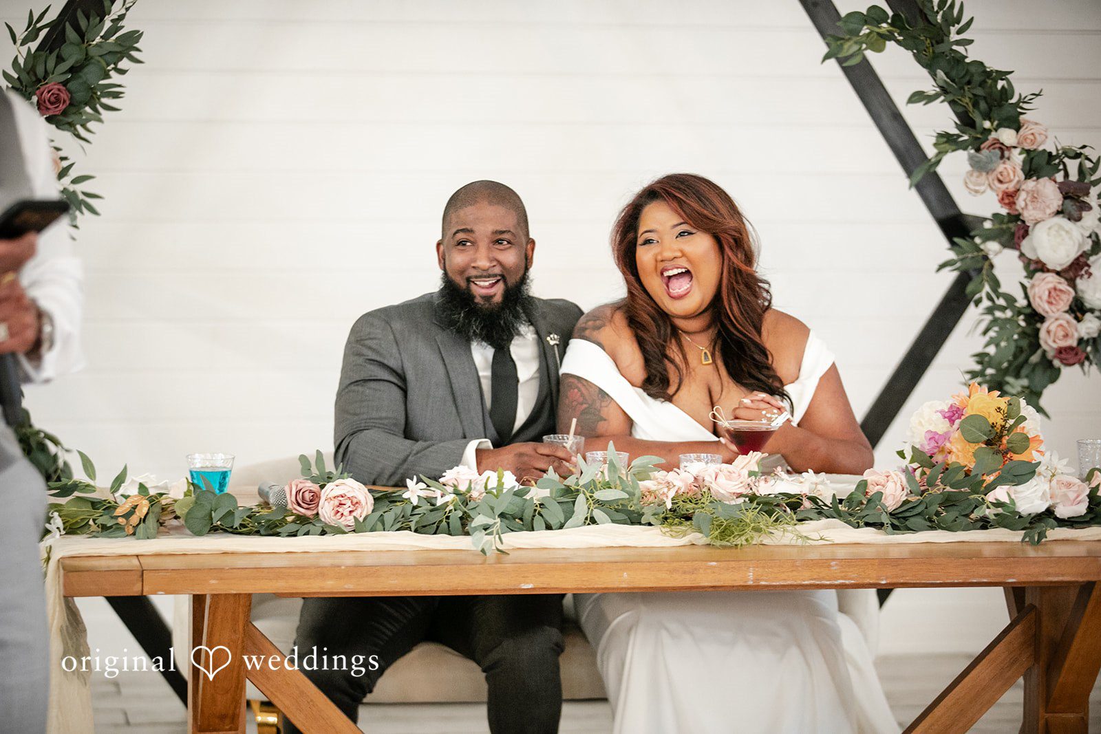 A joyful portrait of the couple from their wedding reception