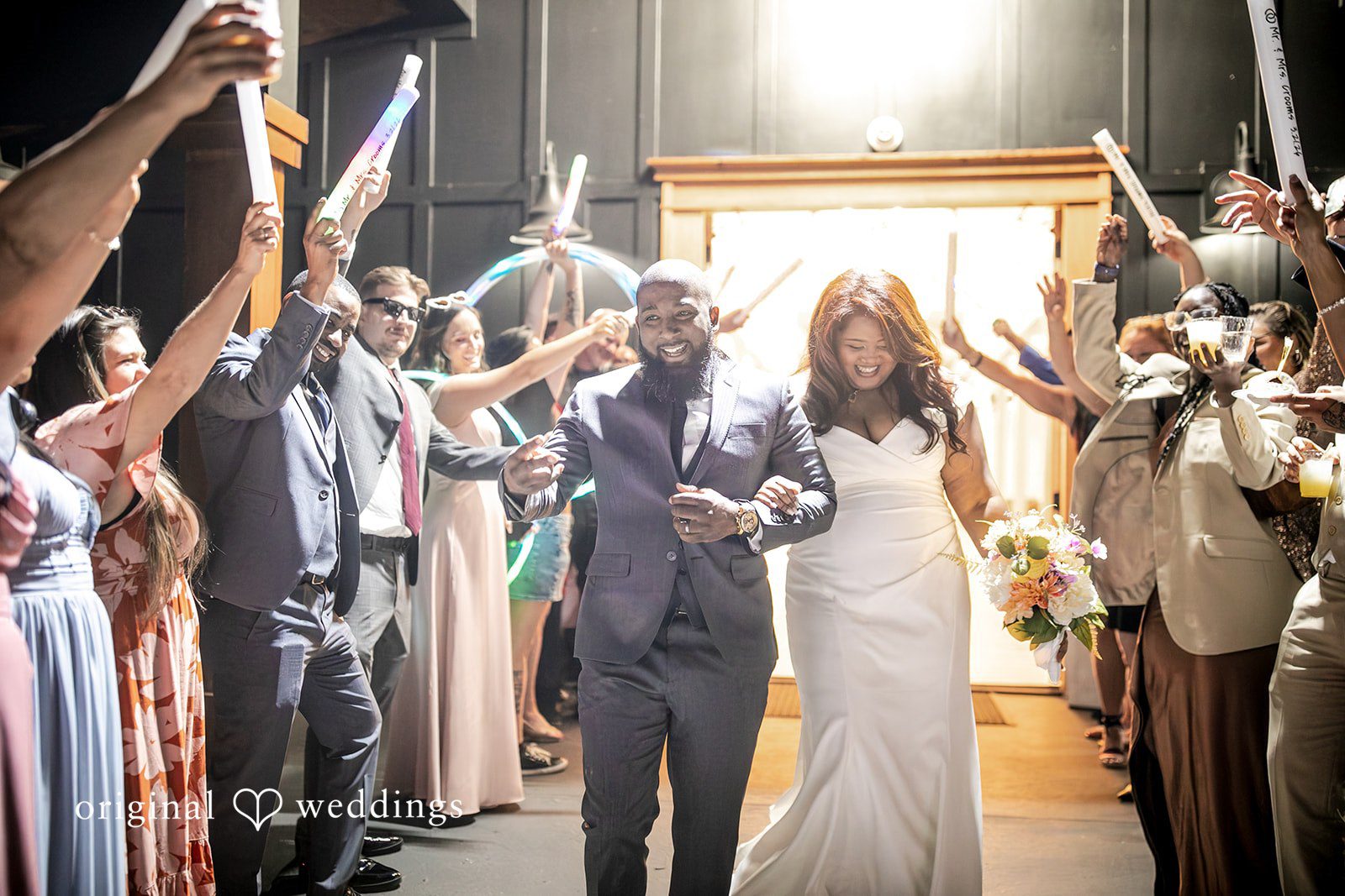 The couple makes a grand exit as guests cheer them on