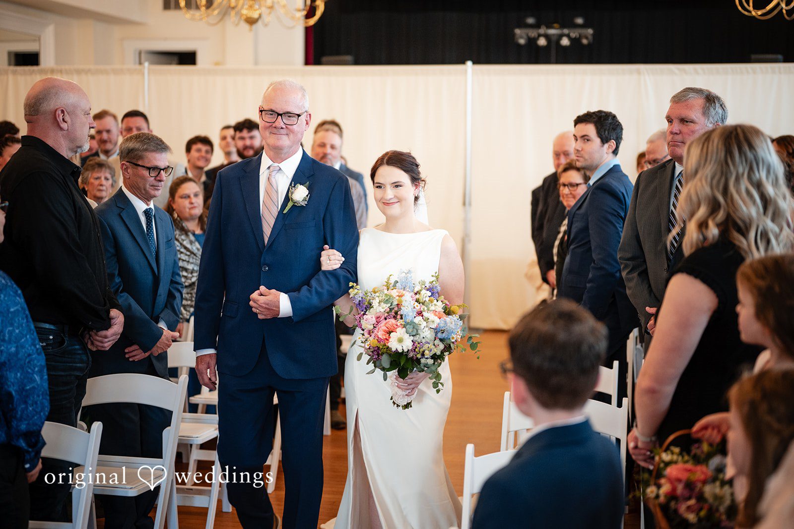 Lovely picture of bride walking arms in arms with her companion