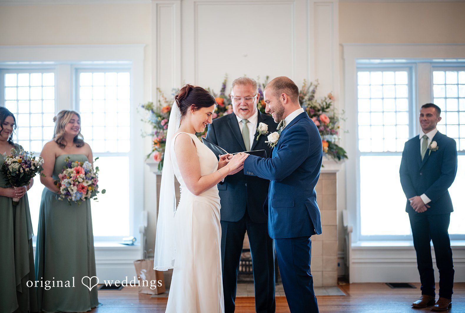 Beautiful picture of couple exchanging rings during ceremony at The Glendale Lyceum by Cincinnati wedding photographers from original weddings