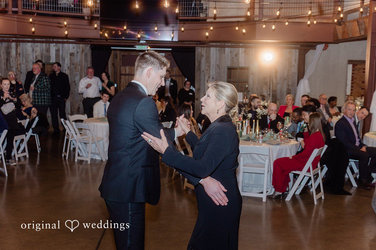 Groom dancing joyfully with family