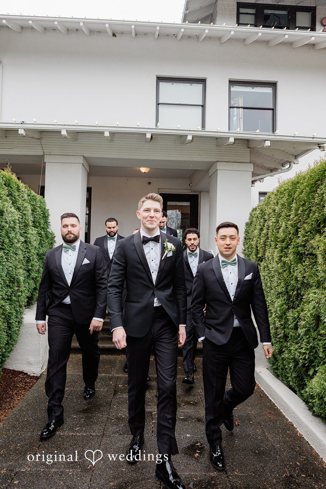 Groom walking with groomsmen at The Olson Mansion