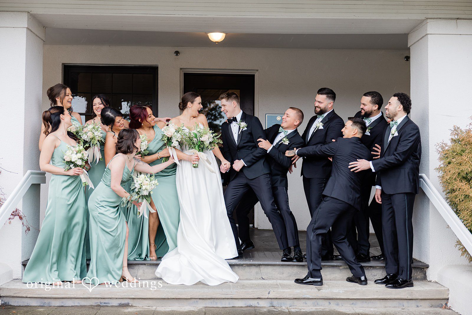 Joyful moment of couple with groomsmen and bridesmaids