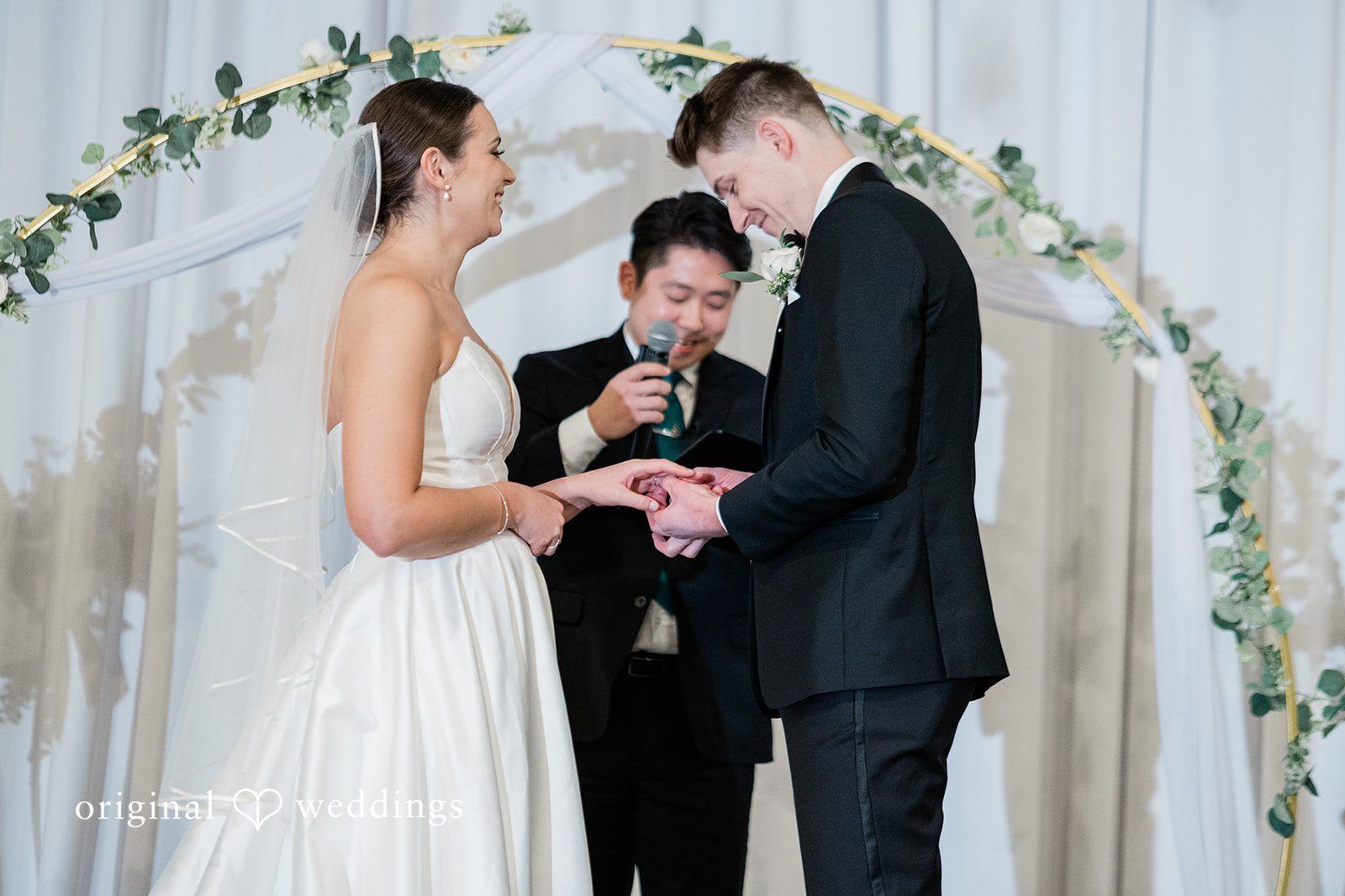 Couple exchanging rings during ceremony at The Olson Mansion