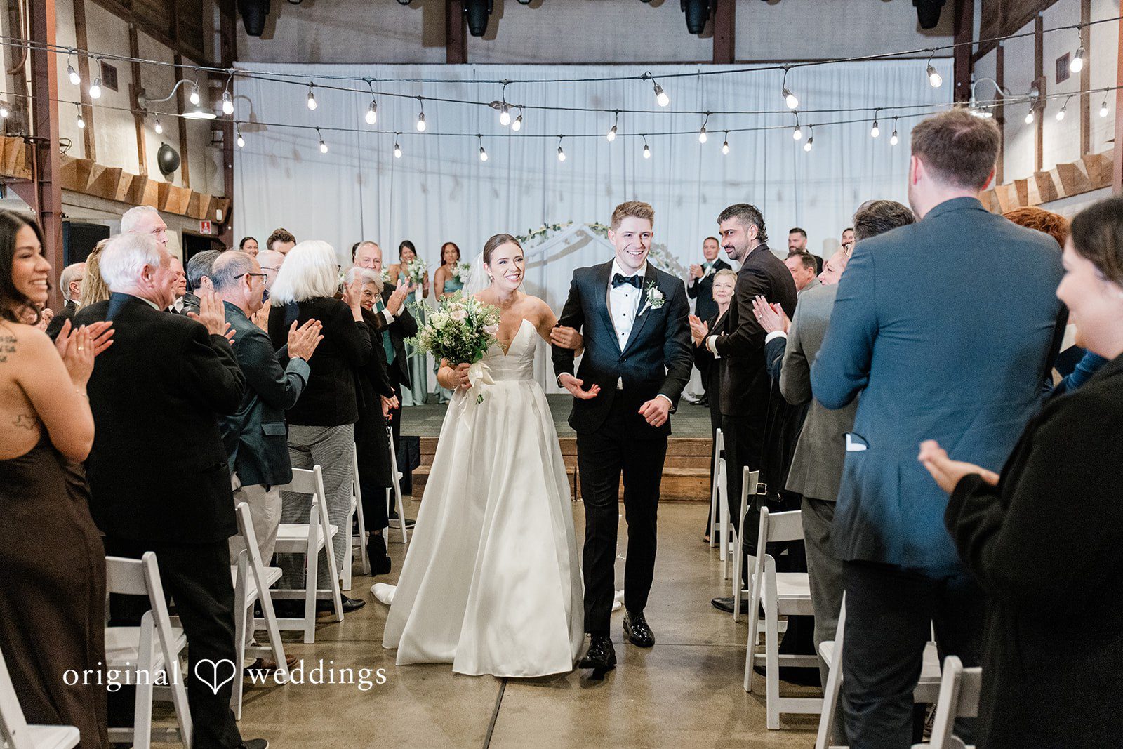Couple walking hands in hands after wedding ceremony