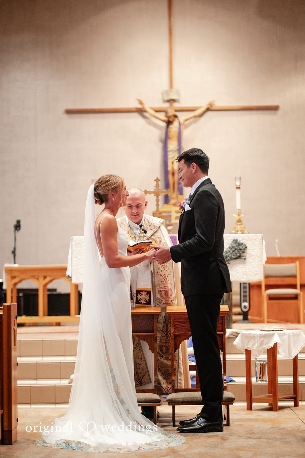 Bride and groom holding hands infront of the priest at The Resort at Longboat Key Club