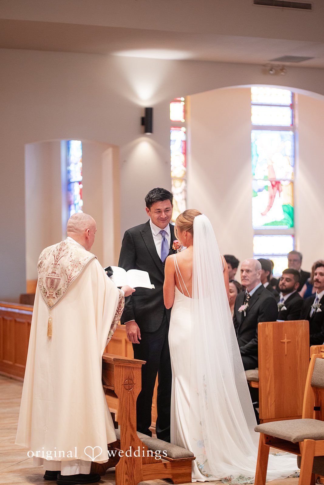Couple standing in front of the priest, looking at each other at The Resort at Longboat Key Club