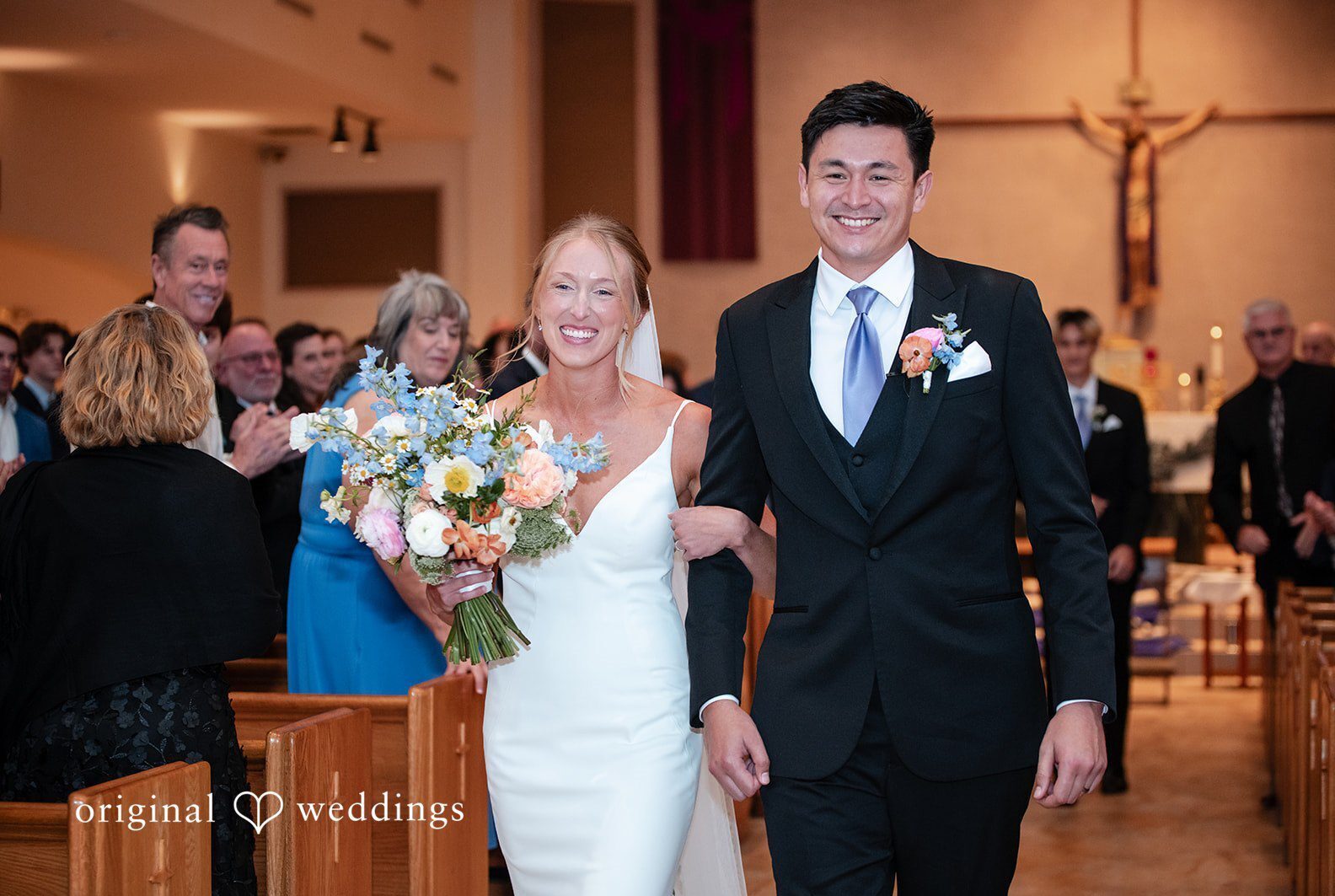 Tampa wedding photographers capturing bride holding arm of groom and walking together at The Resort at Longboat Key Club from Original Weddings